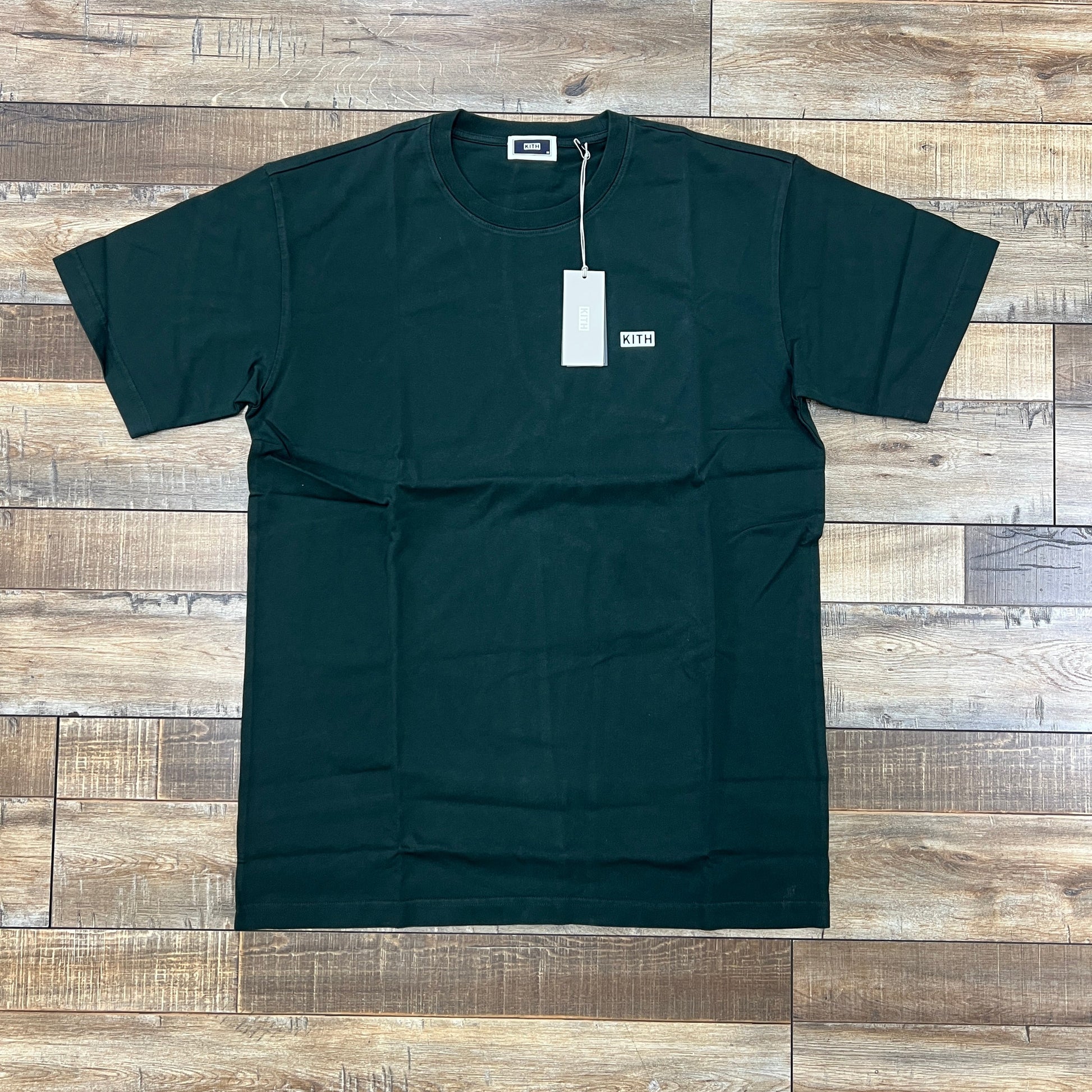 Black Kith LAX Tee Stadium brand new with tag on wooden floor background