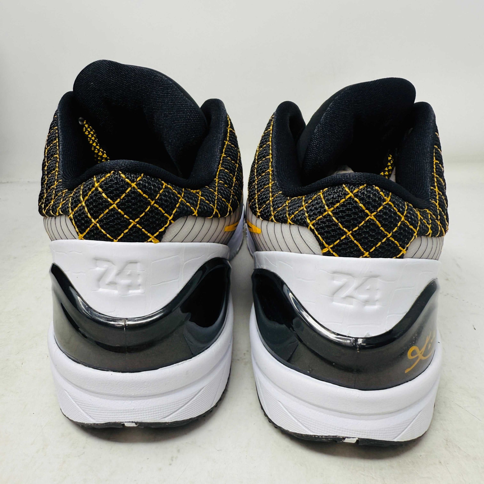 The Nike Kobe 4 Protro White Black Del Sol is a brand-new, authentic Nike sneaker on a shoebox. Predominantly white, it features black and yellow accents with a swoosh logo, a black sole, and yellow-speckled laces, designed for performance and comfort.