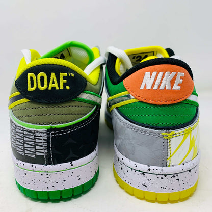 The Nike Dunk Low What the Duck Away University of Oregon PE is a vibrant sneaker featuring green, white, and black patterns with a black Nike swoosh outlined in yellow. It includes white laces, extra laces, a speckled white midsole, and a padded yellow lining atop a bright green shoebox. 100% authentic.