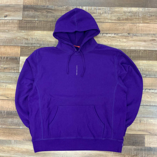 Purple Supreme Micro Logo Hooded Sweatshirt with small front branding, laid flat on wooden floor