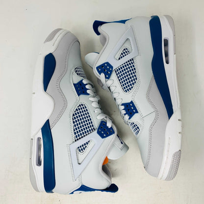 The Jordan 4 Retro Military Blue (2024) sneaker, with white and blue mesh details and a visible air cushion, rests on a black speckled NIKE AIR box with bold orange text. It is 100% authentic, including orange tags, ensuring it’s brand new.