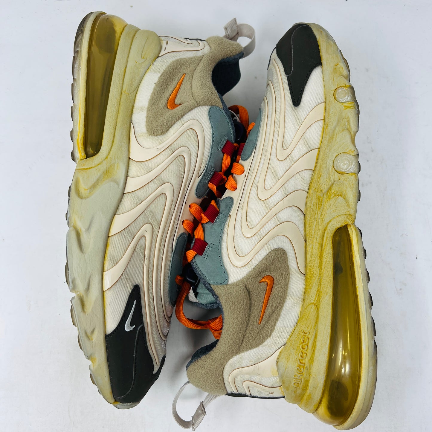 The 2020 Nike Air Max 270 React ENG Travis Scott Cactus Trails features tan, orange, and yellow hues atop its black and red box. It includes a white shoelace as extra laces, with a price tag of $330.