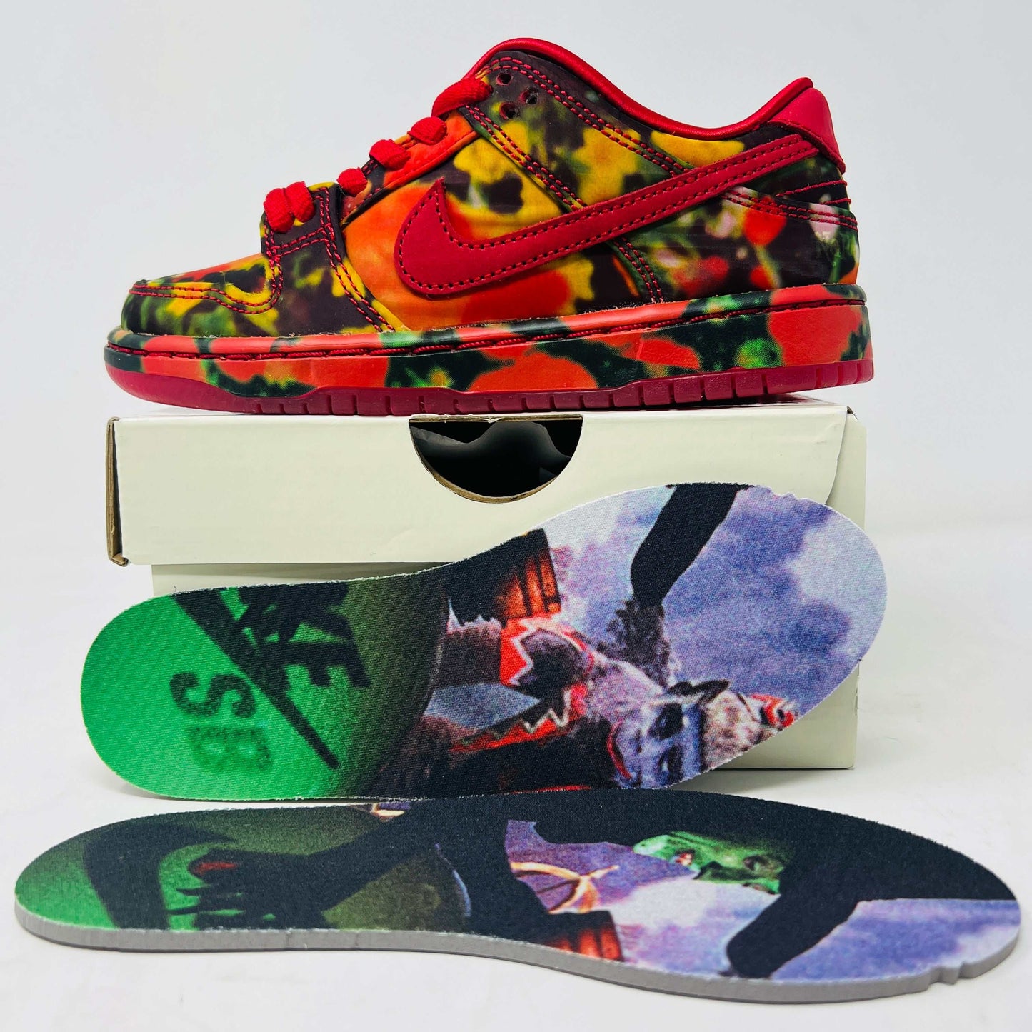 Nike SB Dunk Low The Wizard of Oz Poppy Field sneakers with red and green colorway, poppy flower graphic, suede and leather upper.