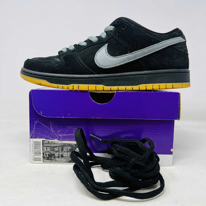 Nike SB Dunk Low Fog black sneaker with gray swoosh, yellow sole, extra black laces, and purple box from 2021