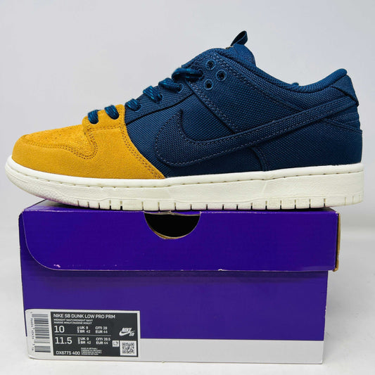 Side view of Nike SB Dunk Low Pro PRM sneaker in yellow and navy on purple shoebox
