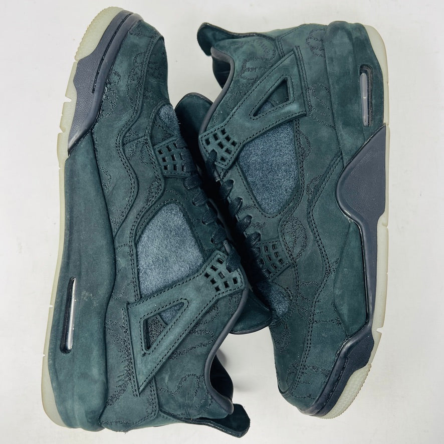 A dark green suede sneaker with a textured design, reminiscent of OG ALL styles, sits atop a matching box. Tagged size 10.5, it features a small red Jumpman logo and includes a XX AIR keychain from its 2017 release. Product: Jordan 4 Retro Kaws Black by Jordan.