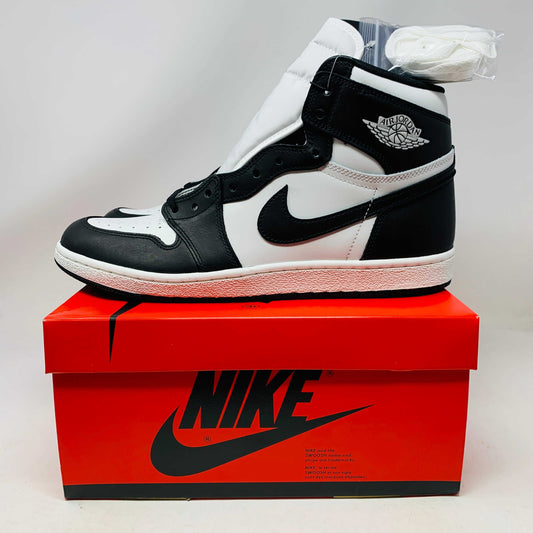 Jordan 1 Retro High 85 Black White sneaker on red Nike box with extra white laces 2023 edition