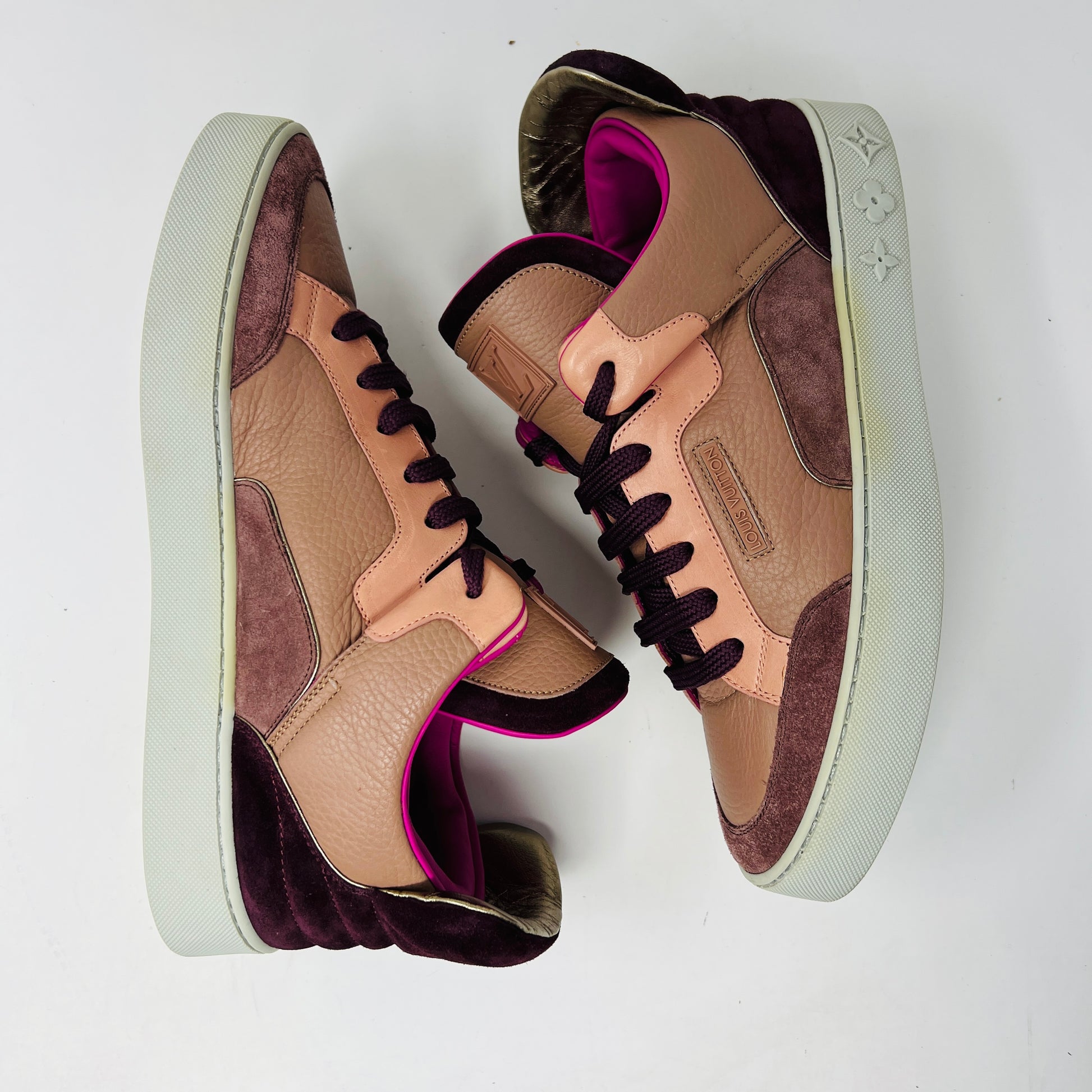 The Louis Vuitton Don Kanye Patchwork high-tops showcase brown and pink leather details with dark brown laces and a logo on the tongue. The white soles have a pink touch at the collar, ideal for size 7 fashionistas seeking extra flair.