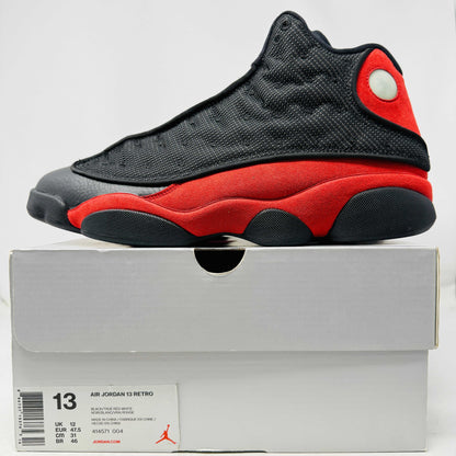 Jordan 13 Retro Bred 2017 sneaker in black and red with clean uppers and light sole wear on a white box.