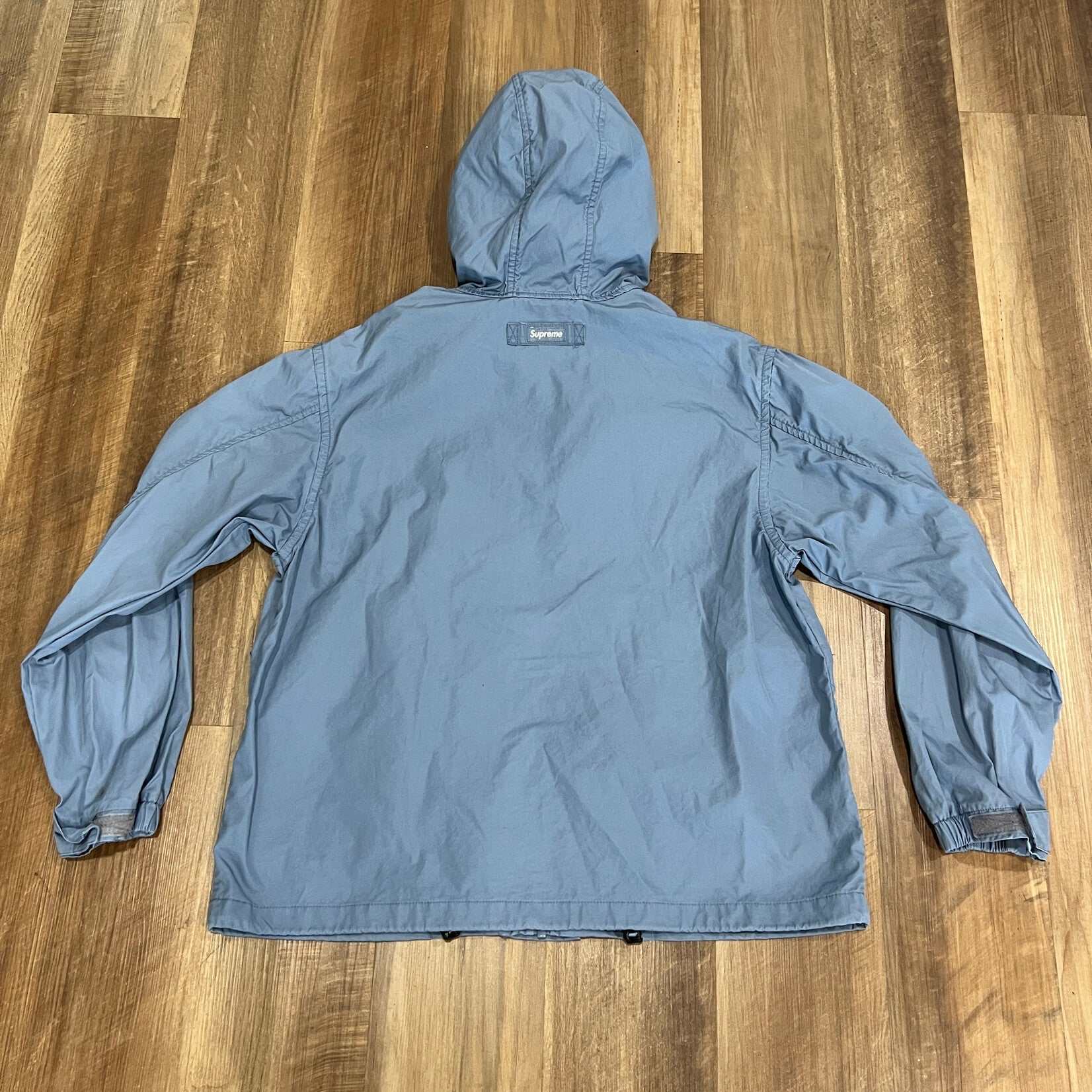 Supreme Mesh Pocket Cargo Jacket Slate, preowned, hooded design on wooden floor.