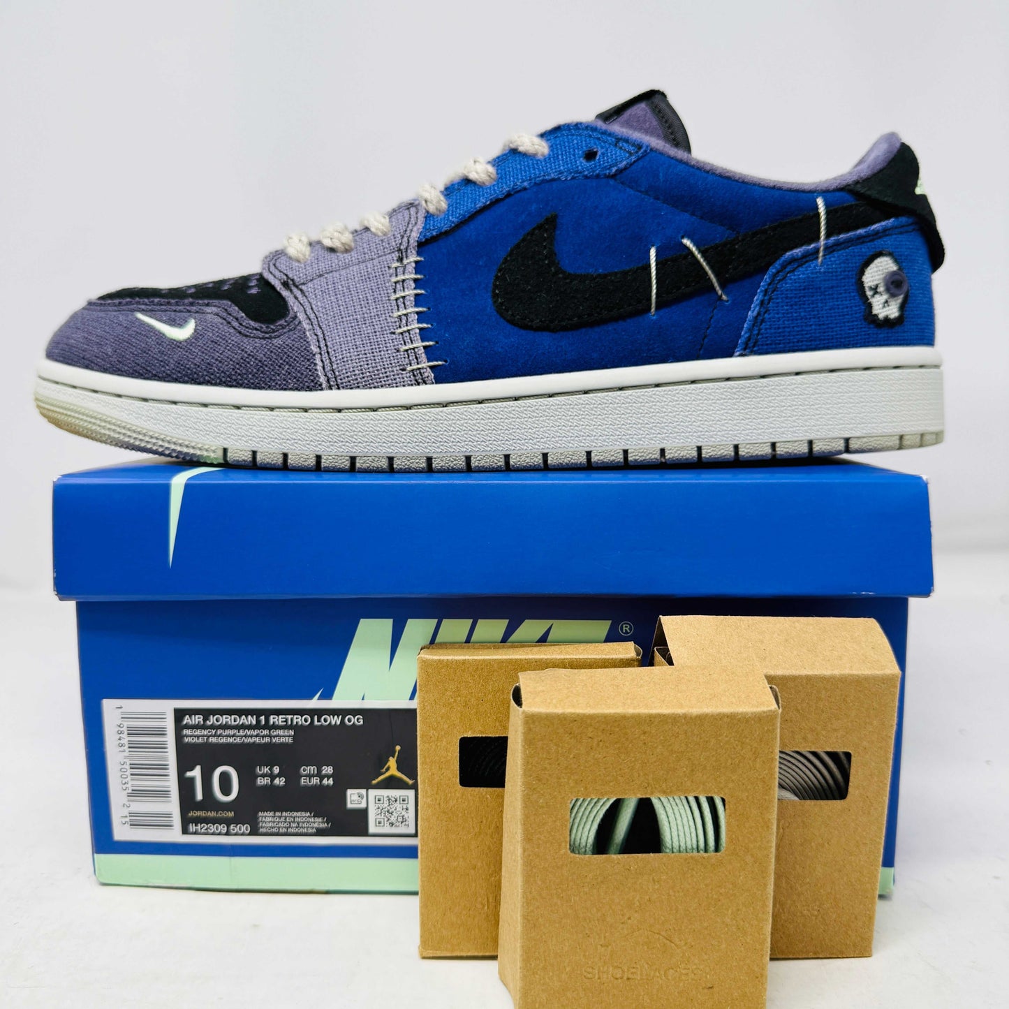 Jordan 1 Retro Low OG Zion Williamson Voodoo Alternate sneaker with blue and black colors on Nike box with extra laces.