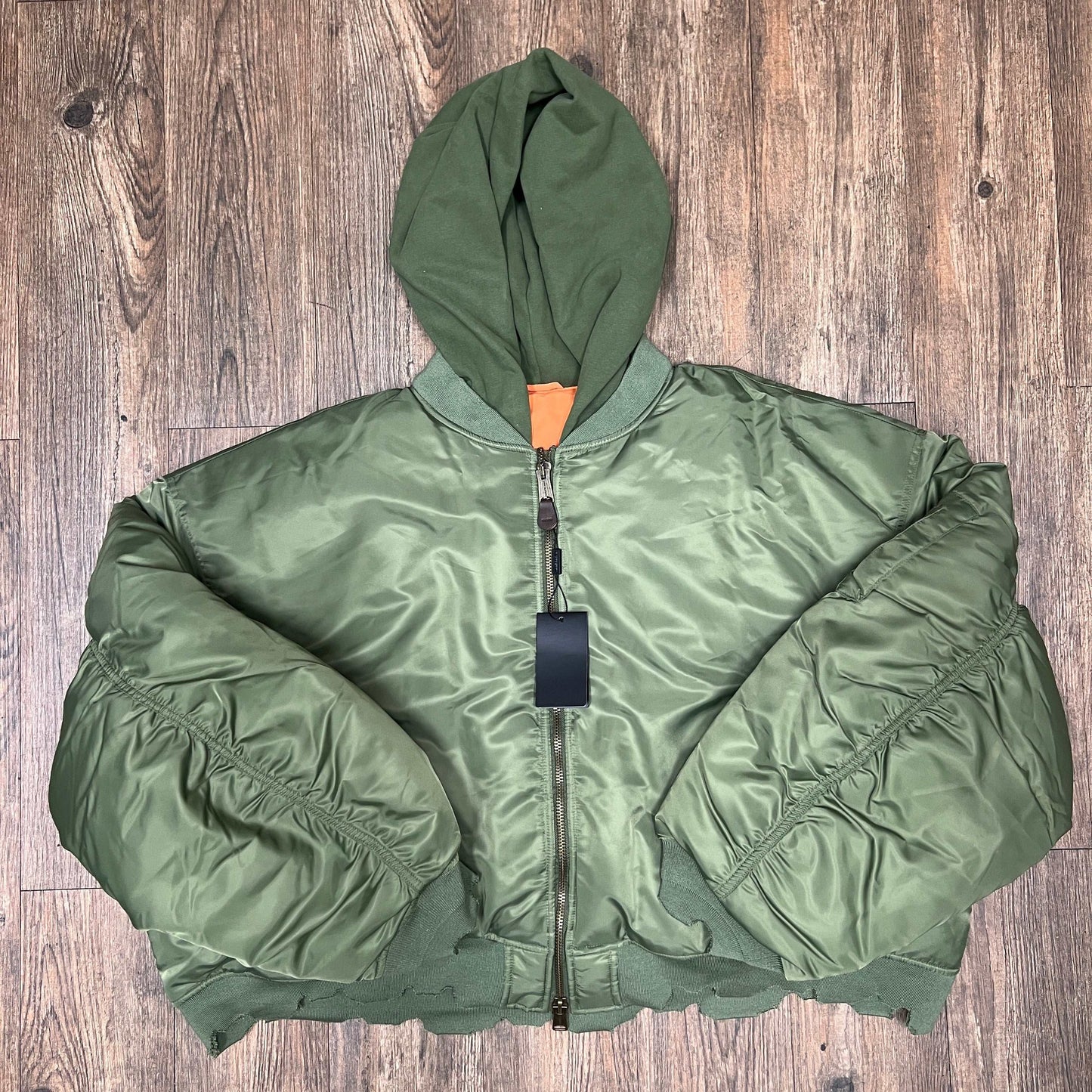 Raspberry Hills GV Gallery green bomber jacket with hood on wooden floor brand new