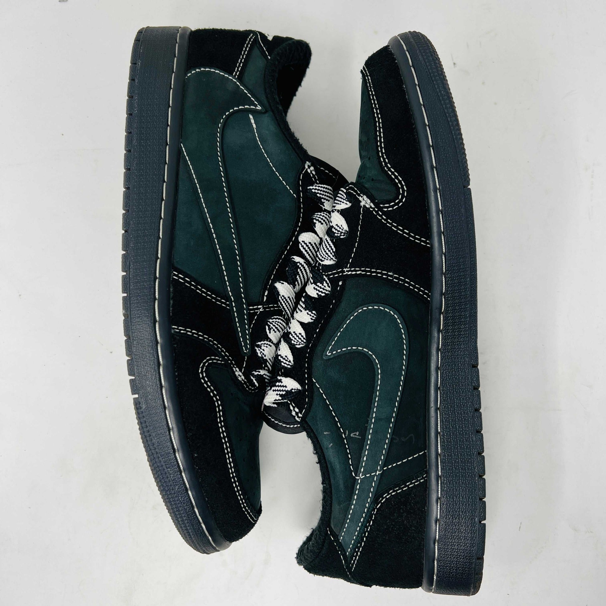 A side view of the Jordan 1 Retro Low OG SP Travis Scott Black Phantom sneaker in black and dark gray with white stitching, size 9.5, displayed on a box with clean uppers and extra laces. A blue sticker shows A2301, with the box label priced at $945.
