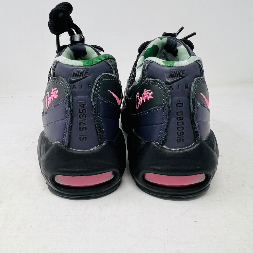 Introducing the Nike Air Max 95 SP Corteiz Pink Beam, black sneakers with textured design and purple accents. They feature a pink logo on the tongue, green and gray camo inner lining, black laces with toggle fasteners, fitting perfectly into 2021 fashion trends; available without a box.