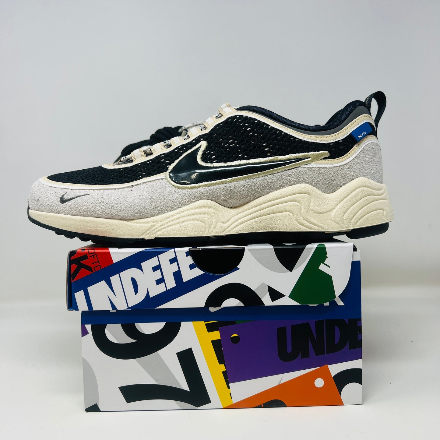 Nike Air Zoom Spiridon Undefeated Phantom sneaker with extra laces on a branded box, 2025 model.