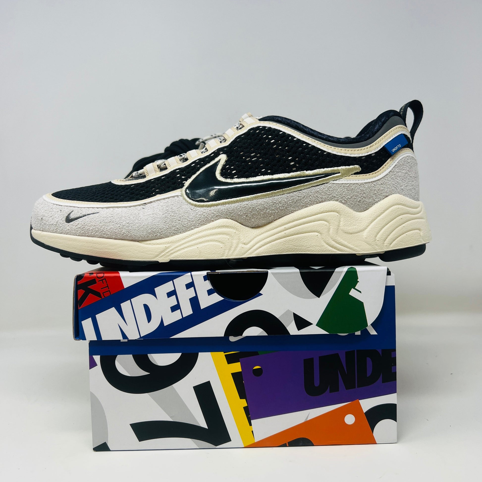 Nike Air Zoom Spiridon Undefeated Phantom sneaker with extra laces on a branded box, 2025 model.