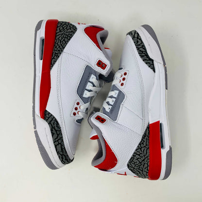 The Jordan 3 Retro Fire Red (2022) (GS) features white, red, and gray colors with elephant-print accents on a black-and-gray patterned box. The box has a red jumping silhouette and bold AIR lettering, making this BRAND NEW release ideal for collectors and enthusiasts.