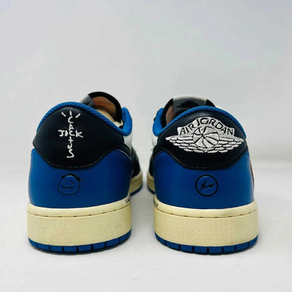 The Jordan 1 Retro Low OG SP Fragment x Travis Scott sneaker, with a blue, black, and white color scheme, sits on a Nike box. Two extra shoelace pairs in black and pink are included in clear bags to keep your look fresh with authentic VNDS style.