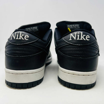 Nike SB Dunk Low Civilist sneakers, black with white soles and yellow tongue details, showcased on a white backdrop. They blend style and comfort effortlessly, making them a standout in 2020 sneaker collections.