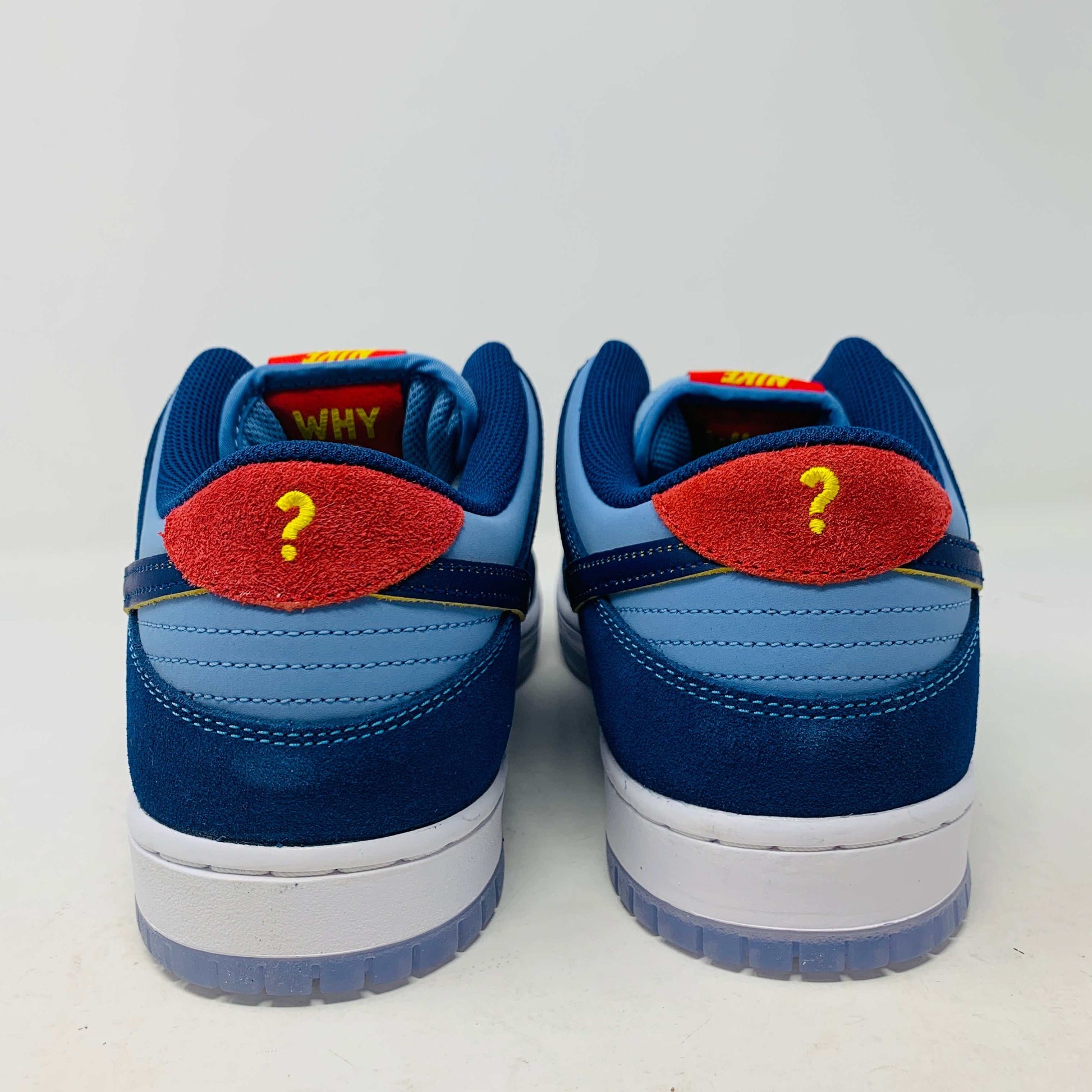 Nike SB Dunk Low "Why So Sad?" sneakers, rear view showcasing unique red and blue design with question mark detail.