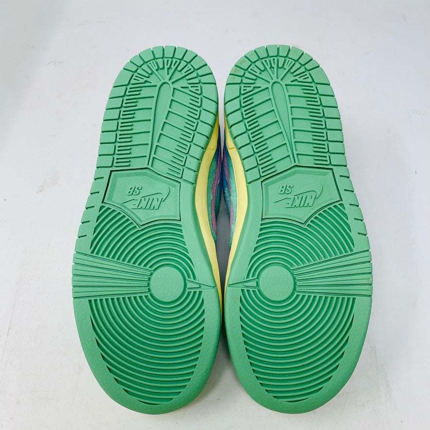 The 100% authentic Nike SB Dunk Low Verdy Visty (PS) sneaker showcases blue, pastel yellow, pink, and mint green accents with textured fabric and a pink swoosh. It is displayed atop a white Nike SB shoebox.