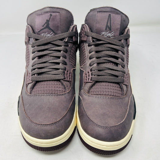 The Jordan 4 Retro SP A Ma Maniére Violet Ore showcases a side view in a mauve hue, with clean uppers, mesh details, and visible air cushioning. Displaying minor creases, it rests atop a matching mauve box featuring the Nike Air logo.
