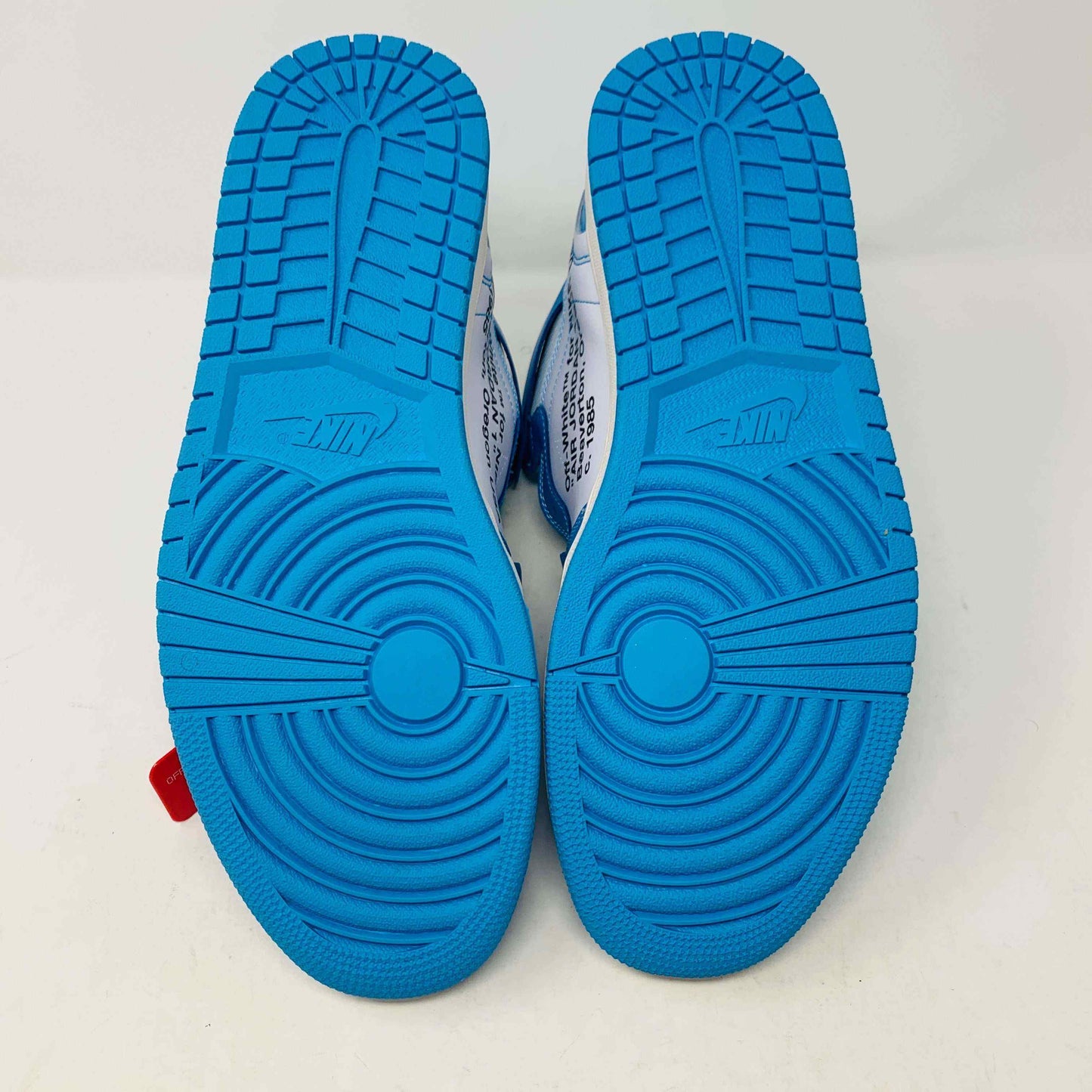 Brand new Jordan 1 UNC Off White sneakers with blue soles and accessories, 2018 release.