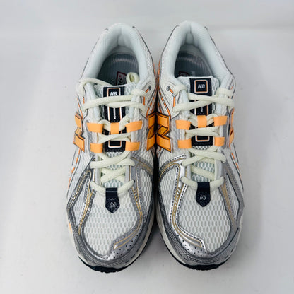 New Balance 1906R ASOS Exclusive Neon Pack in orange on display box.