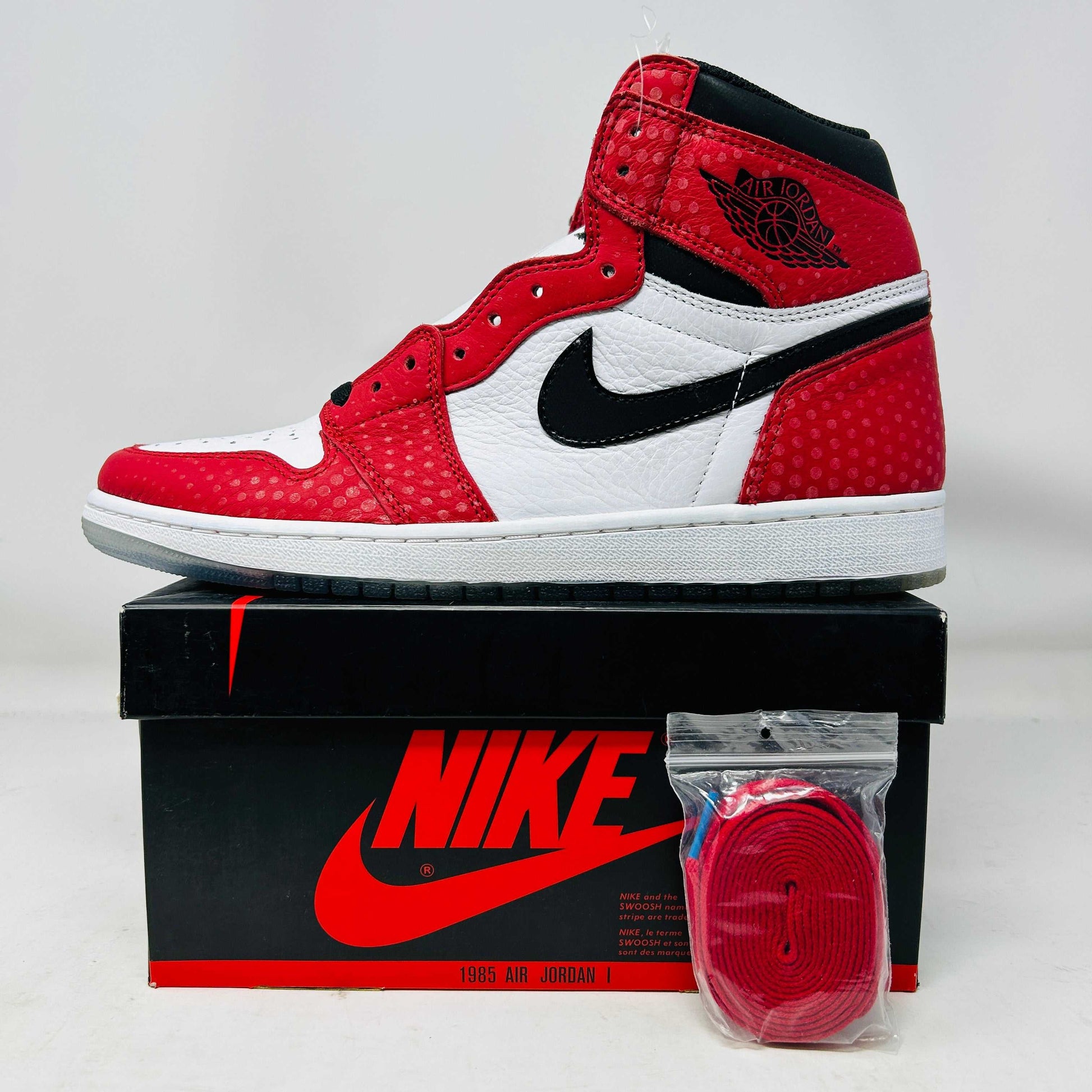 Jordan 1 Retro High Spider-Man Origin Story sneaker red white black on Nike box with extra laces