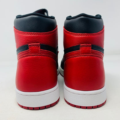 The Jordan 1 High Bred 2016 sneakers, by Jordan, are brand-new black and red high-tops with a white sole. Viewed from above, they showcase an unlaced look with a perforated design on the toe area.