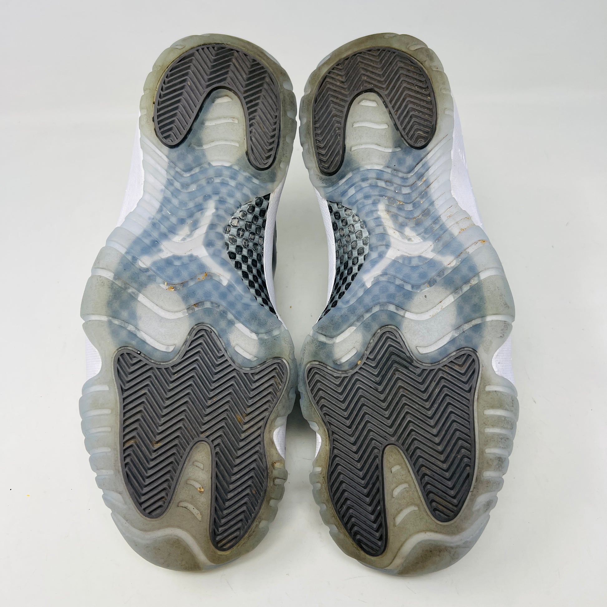 The Jordan 11 Retro Cool Grey (2021) sneaker, featuring clean gray and white uppers with glossy patent leather accents and white laces, is displayed on a gray Nike Air shoebox. The shoe is authentic in size 9.5, with the box in good condition.