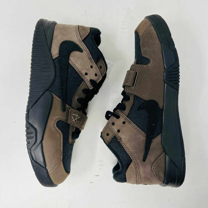 The Jordan Jumpman Jack TR Travis Scott Dark Mocha (PS) sneakers feature a black swoosh, textured sole, black mesh panels, brown suede overlays, and a strap near the laces. They are displayed side by side on a plain white background.