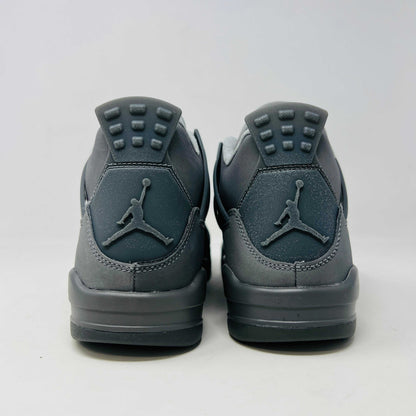 The Jordan 4 Retro SE Paris Olympics Wet Cement (GS), a brand-new gray sneaker, sits atop its pristine box. Featuring mesh and suede elements, it has a visible air unit in the midsole and a rubber outsole, poised to make an impression in 2024 against a plain white background.
