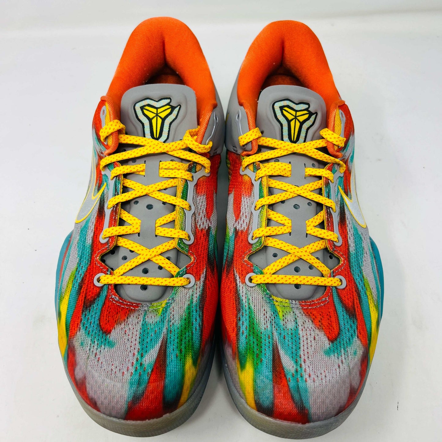 The Nike Kobe 8 Protro Venice Beach (2024) sneakers, featuring vibrant red, blue, yellow, and green brushstroke patterns with clean uppers and yellow laces paired with an orange lining, boast excellent condition at 8.5/10. A distinct logo adorns the gray tongue as they lay side by side on a white background.