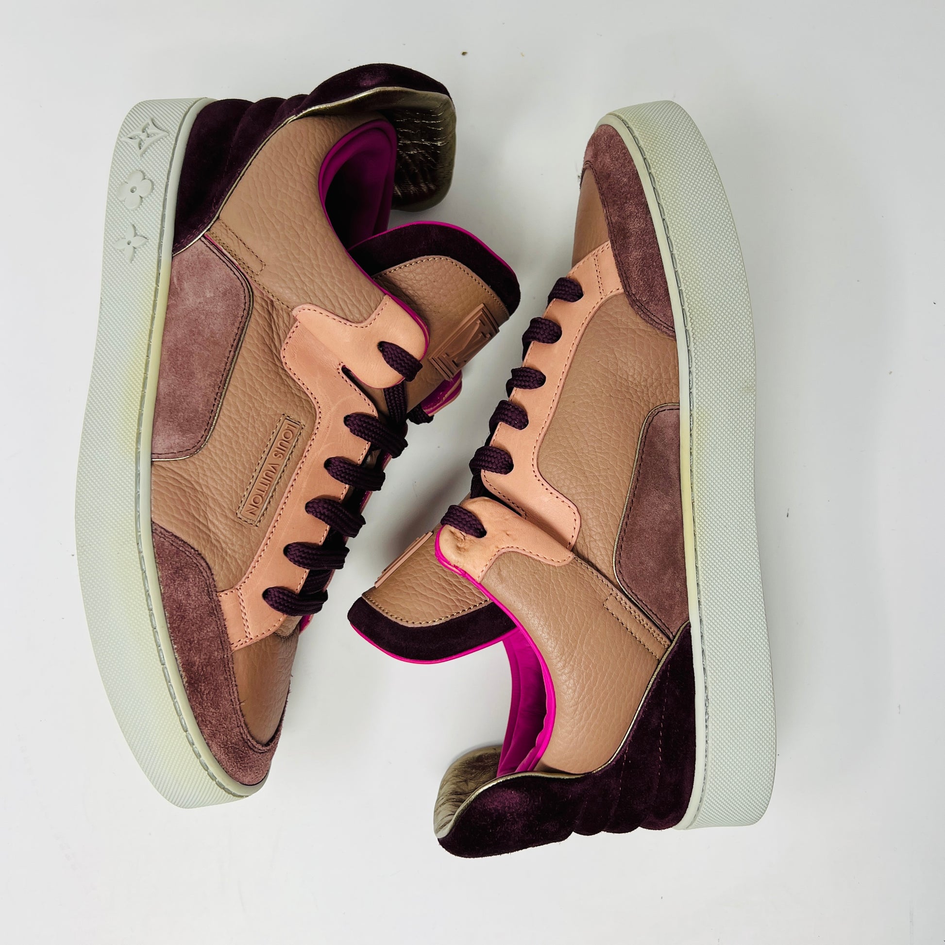 The Louis Vuitton Don Kanye Patchwork high-tops showcase brown and pink leather details with dark brown laces and a logo on the tongue. The white soles have a pink touch at the collar, ideal for size 7 fashionistas seeking extra flair.
