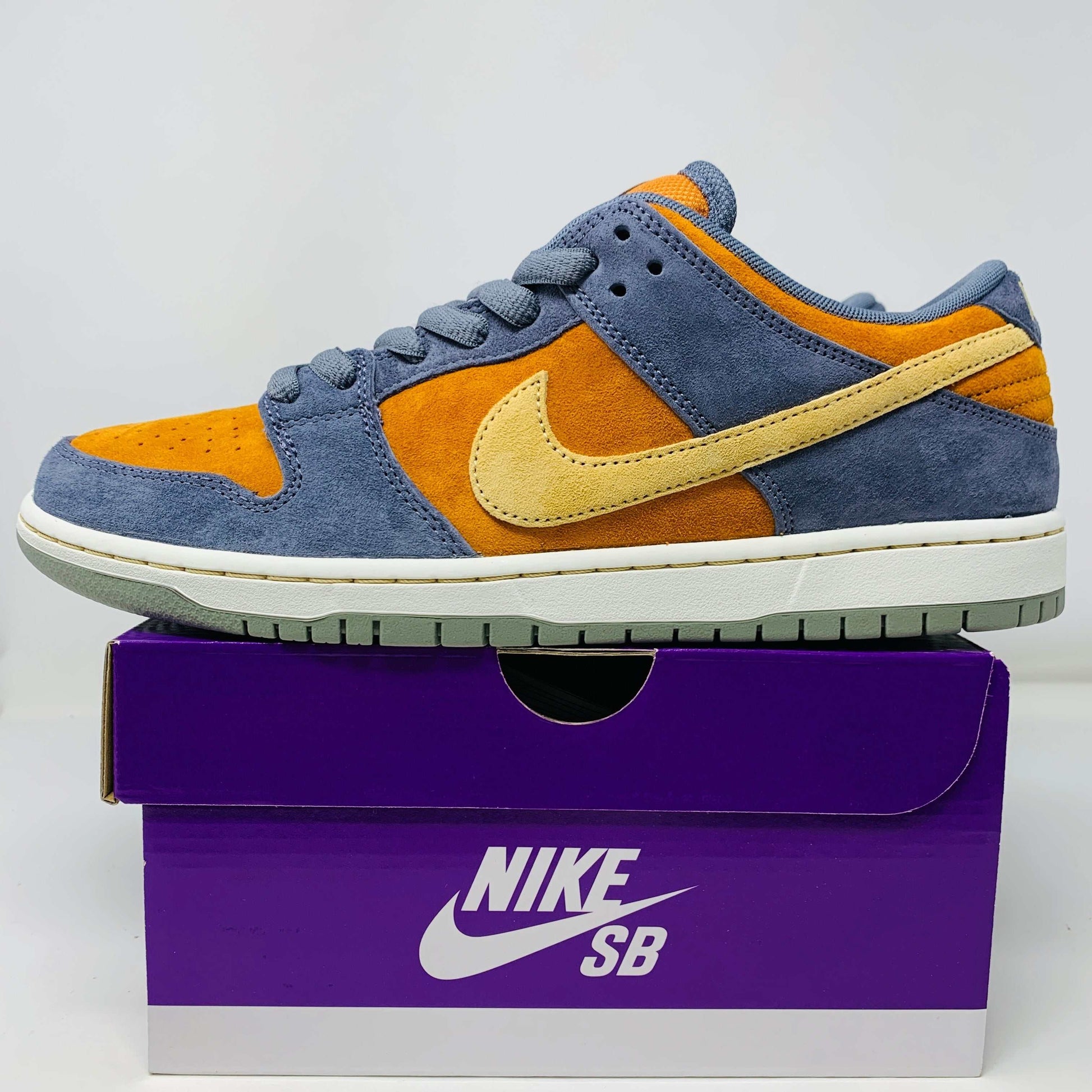 Nike SB Dunk Low Light Carbon Monarch sneakers showcasing suede colorway.