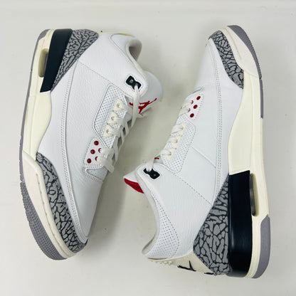 Jordan 3 Retro White Cement sneakers on Nike box, 2023 edition.