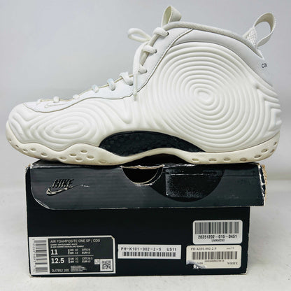 White Nike Air Foamposite One Comme des Garcons Homme Plus sneaker on black Nike box, 2021 model
