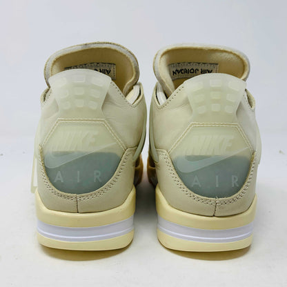 A beige Jordan 4 Off White Sail W sneaker rests on a box with the authentic Air Jordan logo. It comes with three extra sets of laces in mint, cream, and black labeled SHOELACES, a plastic zip tie, and features a small Jumpman Air tag.