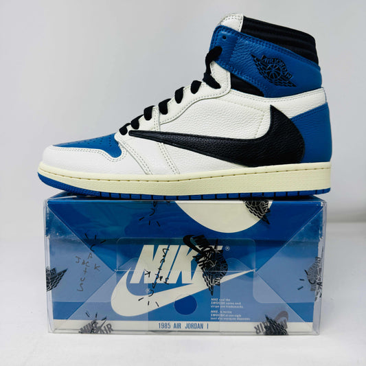 The Jordan 1 Retro High OG SP Fragment x Travis Scott is a new high-top sneaker featuring a blue, white, and black design with a unique backward Nike swoosh. It comes in a transparent, branded box adorned with butterfly and text details, boasting a thick sole and classic 1985 Air Jordan design.
