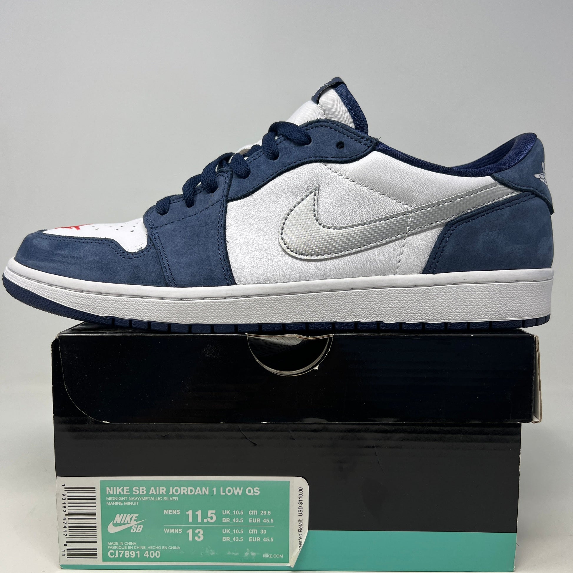 Jordan 1 Low SB Midnight Navy sneakers with blue and white uppers, size 11.5, displayed on original box.