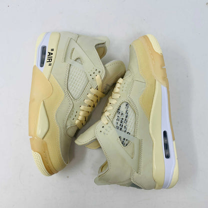 A beige Jordan 4 Off White Sail W sneaker rests on a box with the authentic Air Jordan logo. It comes with three extra sets of laces in mint, cream, and black labeled SHOELACES, a plastic zip tie, and features a small Jumpman Air tag.