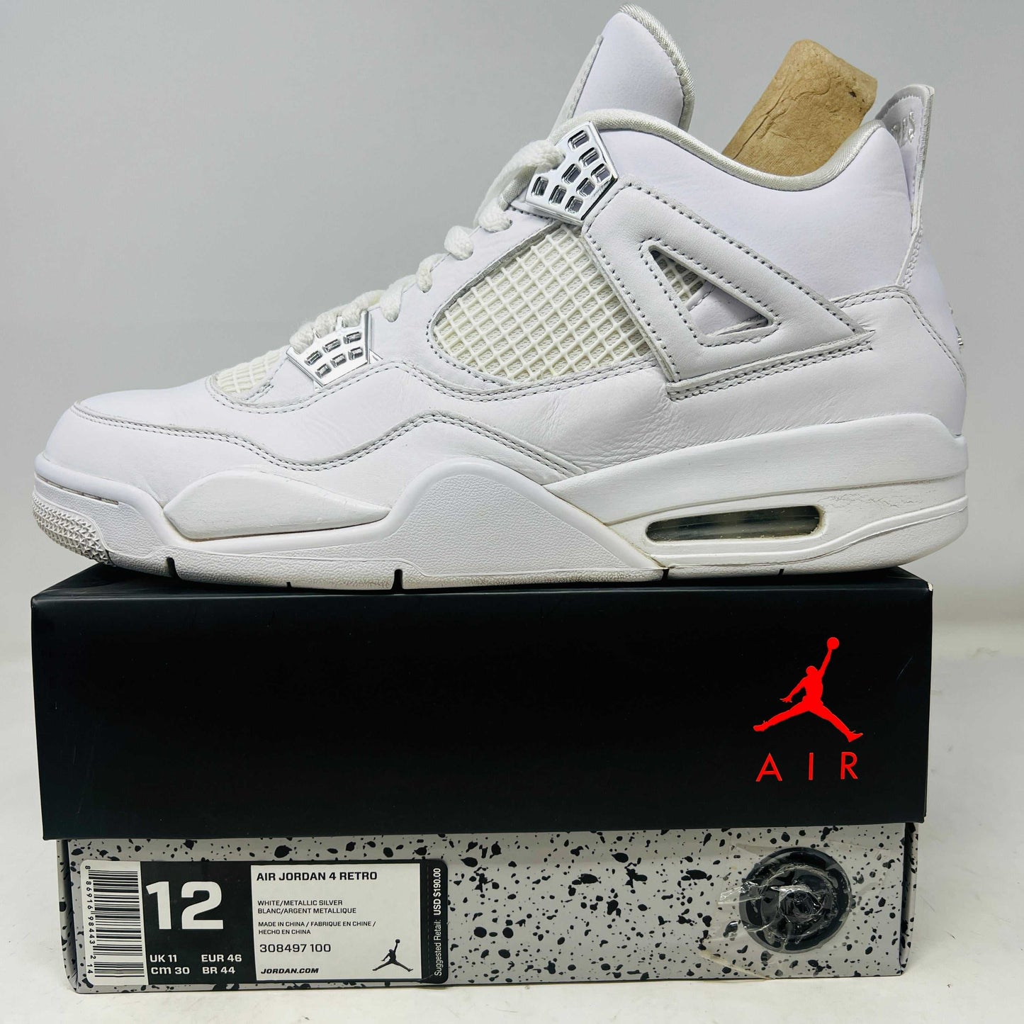 White Jordan 4 Retro Pure Money 2017 sneaker side view on box with red Jumpman logo