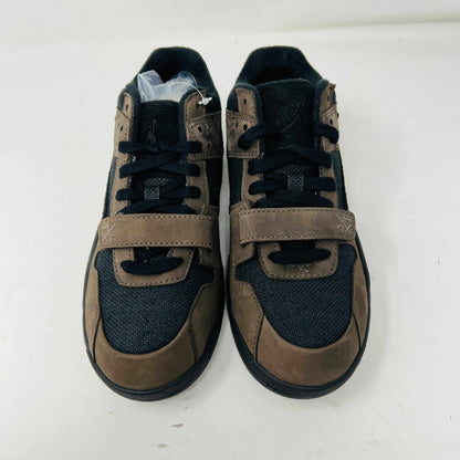 The Jordan Jumpman Jack TR Travis Scott Dark Mocha (PS) sneakers feature a mix of brown and black colors, velcro straps, and laces set on a white background.