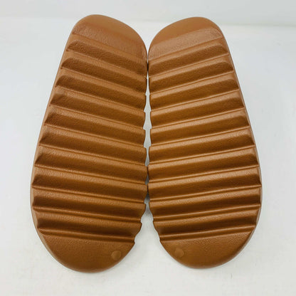 Yeezy Slide Flax with textured sole in neutral color.