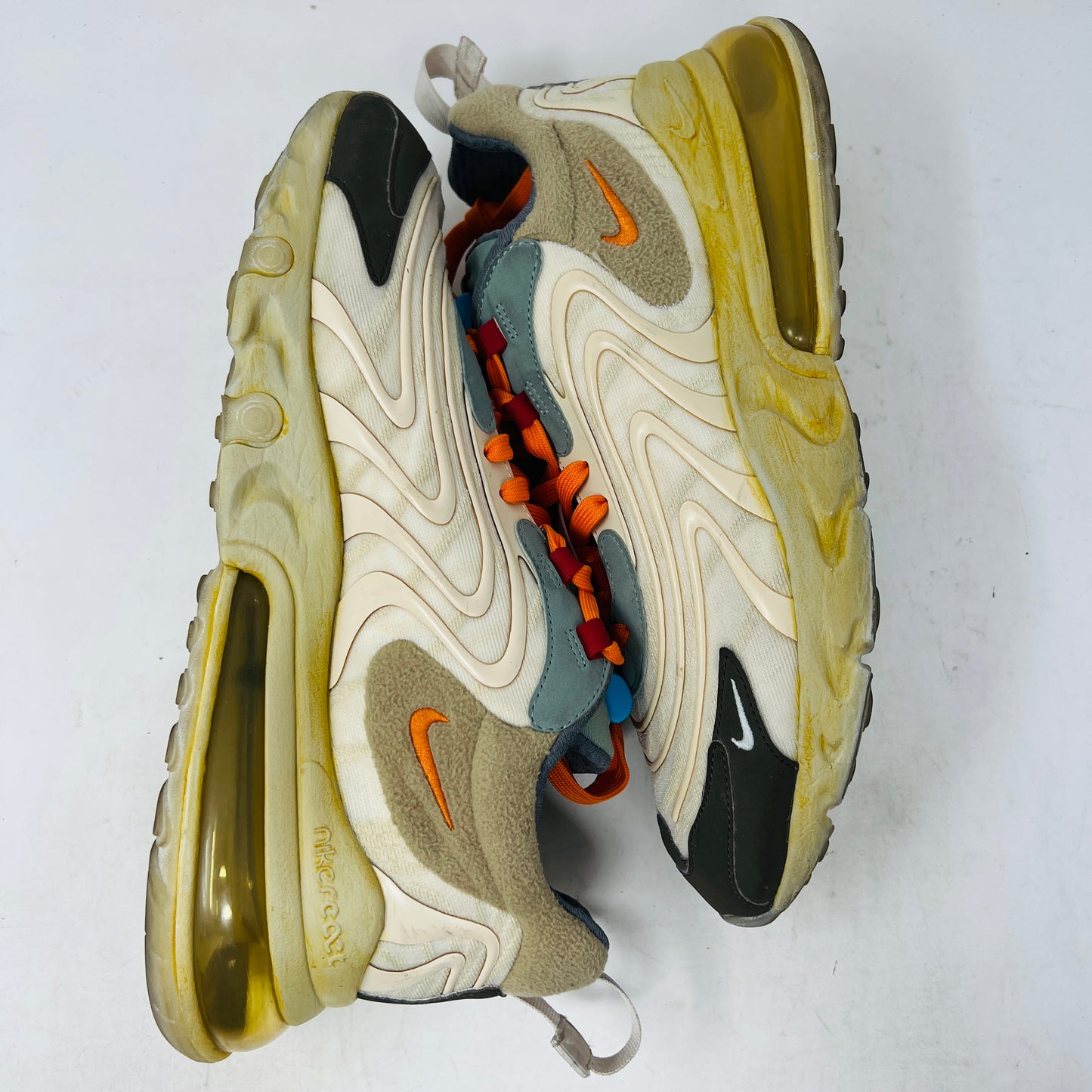 The 2020 Nike Air Max 270 React ENG Travis Scott Cactus Trails features tan, orange, and yellow hues atop its black and red box. It includes a white shoelace as extra laces, with a price tag of $330.