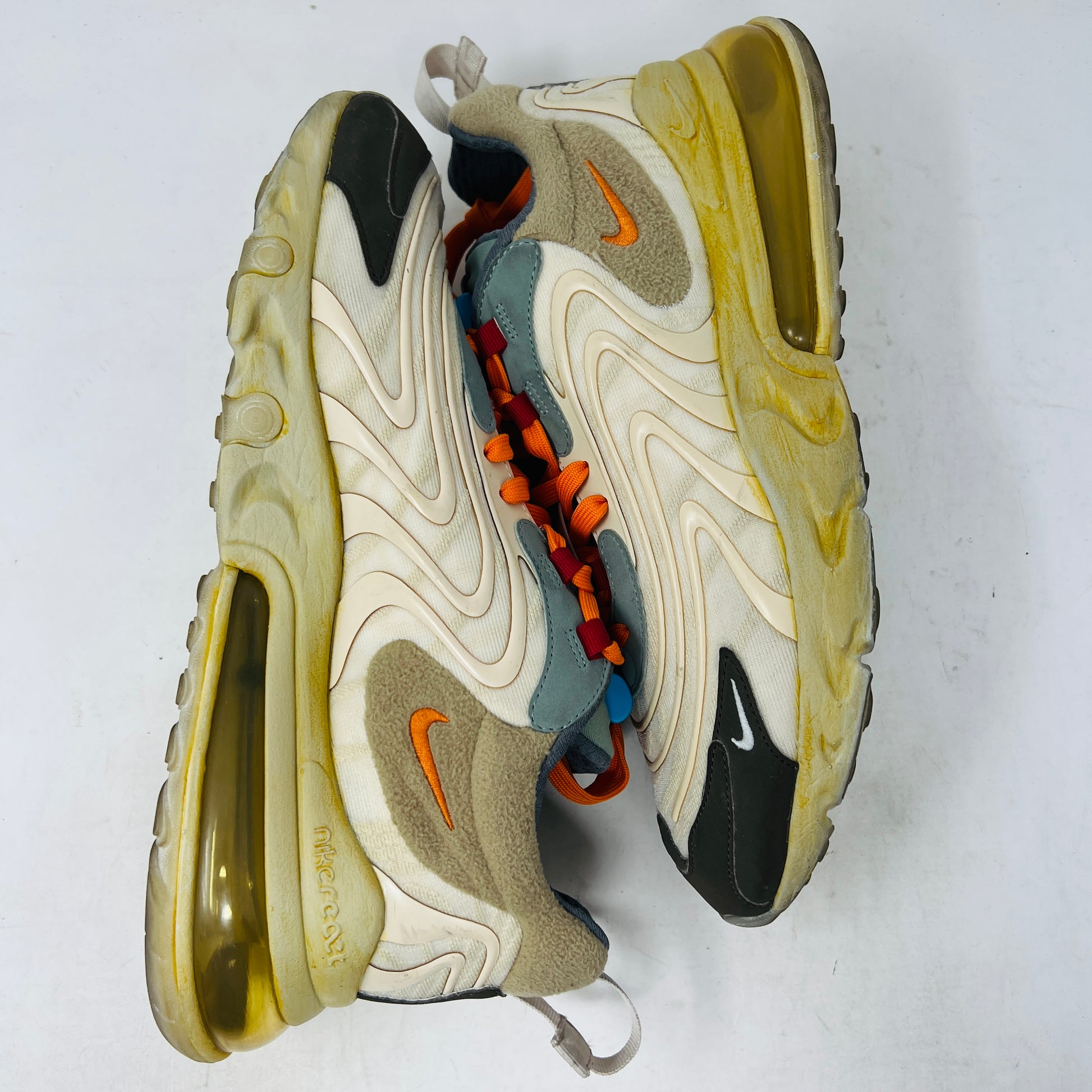 The 2020 Nike Air Max 270 React ENG Travis Scott Cactus Trails features tan, orange, and yellow hues atop its black and red box. It includes a white shoelace as extra laces, with a price tag of $330.
