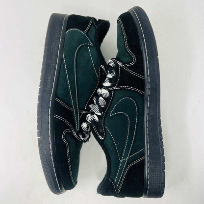 A pair of Jordan 1 Retro Low OG SP Travis Scott Black Phantom sneakers with perforated toe boxes and black and white checkered laces includes extra laces for added style. These authentic Jordans are displayed side by side on a white surface.