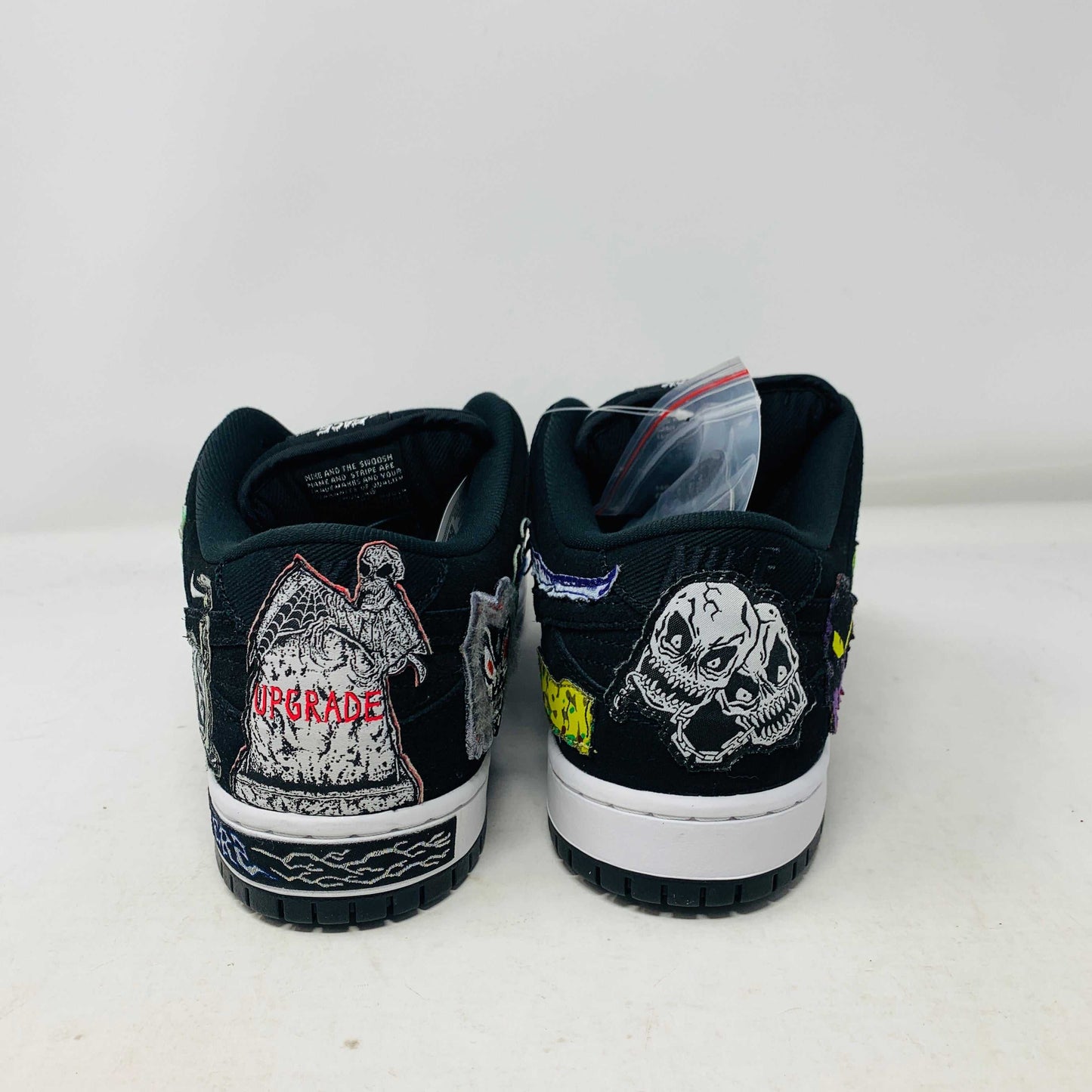 Authentic Nike SB Dunk Low Neckface sneakers, showcasing colorful animal and abstract patches, come in a vibrant green, yellow, and blue Nike SB box on a plain background. All sales final.