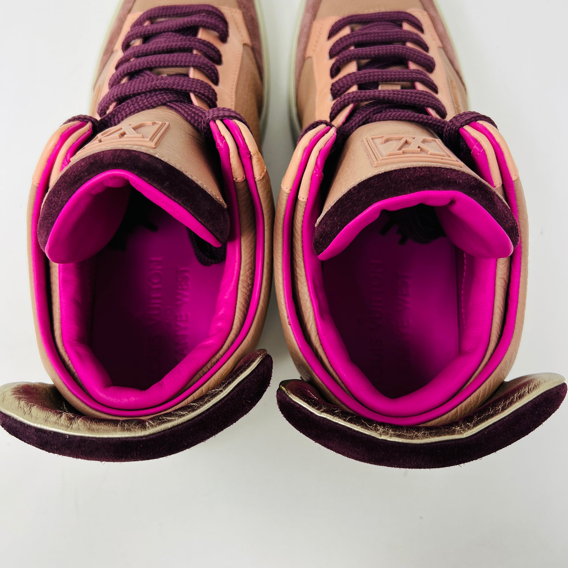The Louis Vuitton Don Kanye Patchwork high-tops showcase brown and pink leather details with dark brown laces and a logo on the tongue. The white soles have a pink touch at the collar, ideal for size 7 fashionistas seeking extra flair.
